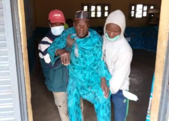Bedridden traditional ruler being taken out of the polling station
