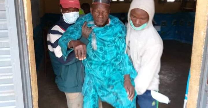 Bedridden traditional ruler being taken out of the polling station