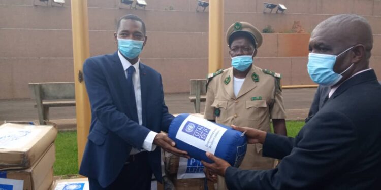 UNDP resident representative in Cameroon, Alasane Ba (L), handing over the biodiversity conservation equipments to the Government