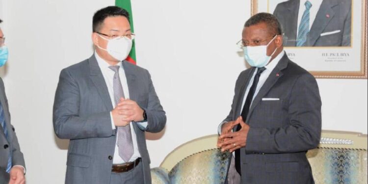 Huawei scribe Terry He (L), and PM Dion Ngute (R)