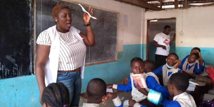 Vanessa Berinyu, Human Resource Manager at DHF schooling the students on the use of menstrual pads