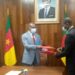 Minister Manaouda Malachie (L), and Hendzi Michel (R) exchanging documents signed to seal the donation