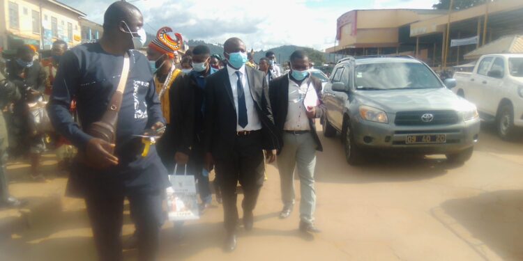 Hon. Agho Oliver, marching along with the population of Bafut - Tubah behind him