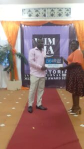 Dr. Stats, receiving his award in Limbe