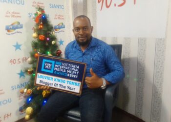 Journalist/Blogger, Louvier Kindo Tombe, with his award inside the studios of Radio Siantou in Yaounde