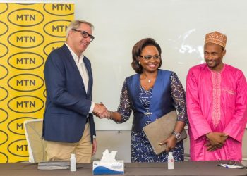 Stephen Blewett (L) greeting Judith Yah Sunday (R) at the signing ceremony