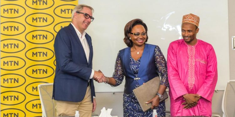 Stephen Blewett (L) greeting Judith Yah Sunday (R) at the signing ceremony