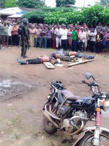 A member of Cameroonian security forces present slain separatist fighters to the population of Noni in crisis-hit North West Region on October 13, 2021