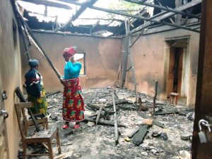 Two women helplessly at the debris of their home razed by government security forces in Ndu, North West Region