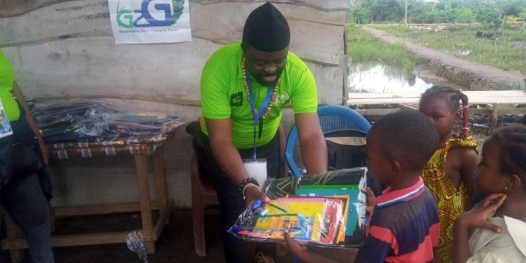 CEO of Grass 2 Grace handing over didactic materials to beneficiary IDPs