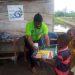 CEO of Grass 2 Grace handing over didactic materials to beneficiary IDPs