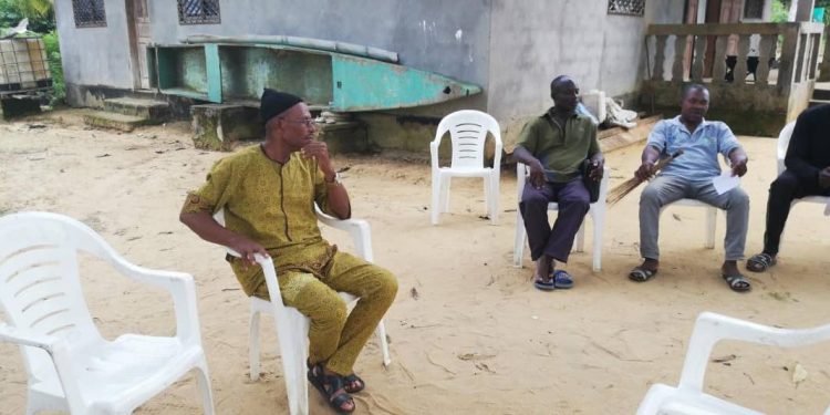 Chief of Ebodje village, Ndjokou Djongo (c) with his collaborators ( extreme right) pondering the faith of his community in the near future