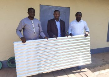 Presentation of the roofing sheets by Hon. Agho Oliver (R), in the presence of the DO of Tubah (L), and the brain behind the move (M)