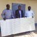Presentation of the roofing sheets by Hon. Agho Oliver (R), in the presence of the DO of Tubah (L), and the brain behind the move (M)
