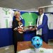 Nadine Perrault (L), and Fernand Sadou exchanging the partnership documents after signing at the Head Office of UNICEF in Yaounde