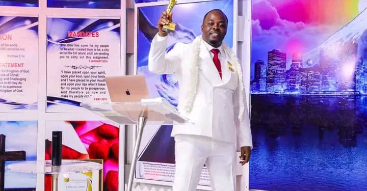 Rev. Steve Olatunde presenting his prize to the church shortly after being decorated