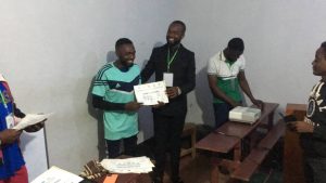 Ayakwe Nick Bayaka, brandishing his certificate 