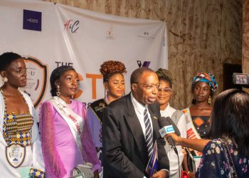 Prof. Jean Emmanuel Pondi talking to the press accompanied by the beauty pageants of the ICT University