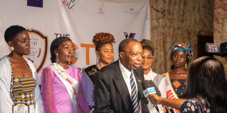 Prof. Jean Emmanuel Pondi talking to the press accompanied by the beauty pageants of the ICT University
