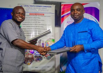 CEO of LOYOC Cameroon (L), and CAMASEJ National President (R), exchanging documents of the MoU