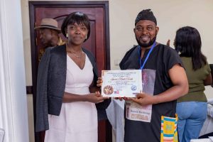 Louvier Kindo (R) receiving his certificate from one of the facilitators of the workshop 