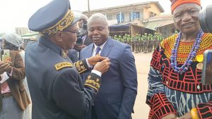 NW regional governor decorating Hon. Agho Oliver Bamenju 