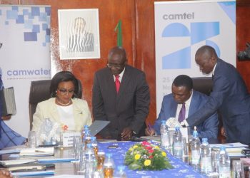 Judith Yah Sunday and Blaise Moussa signing the agreement