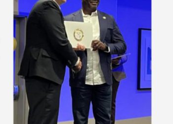 Dr Aloysius Vutumu (right) receiving certification