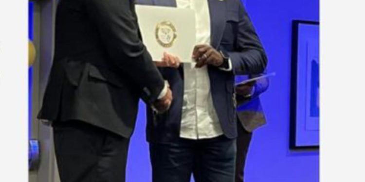 Dr Aloysius Vutumu (right) receiving certification